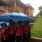 When raining, groups of children can use large umbrellas when walking to their classrooms.